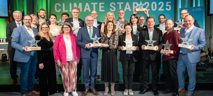Group photo of 16 Climate Star Award winners holding their Awards